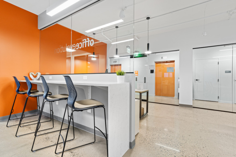 bar seating coworking area with privacy glass and comfortable chairs overlooking reception