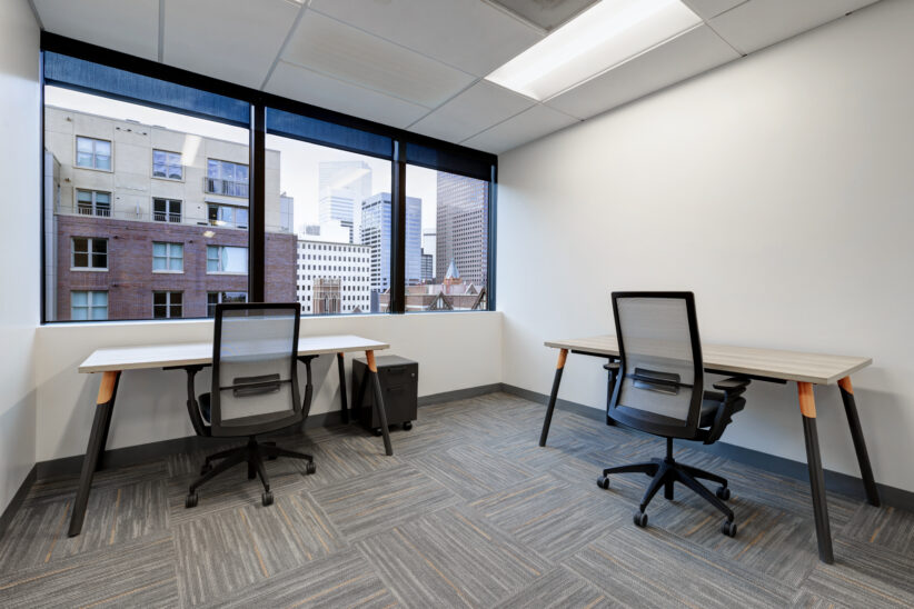 Large windowed office for multiple people with great downtown views, incredible natural light, and standing desks
